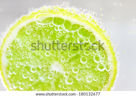 Lime in water on a light background