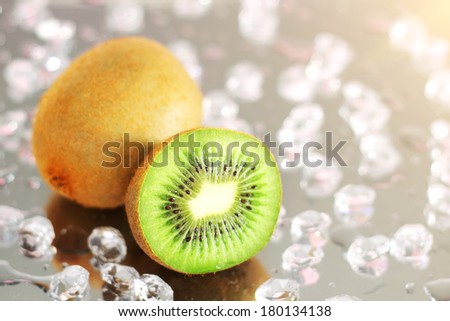 Kiwi and pieces of ice on the mirror surface