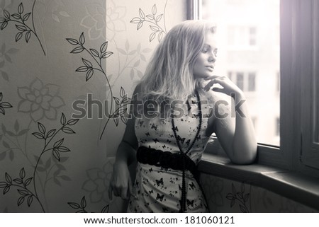 Attractive girl looks out the window