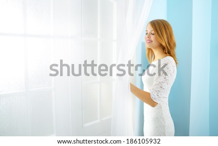 Elegance girl at the window light background