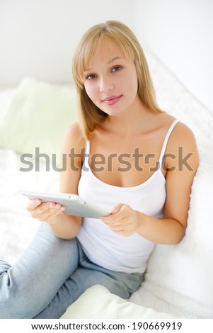 Young attractive girl with tablet pc.  light background