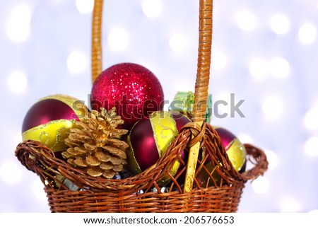 Christmas toys in a wicker basket on a background of lights