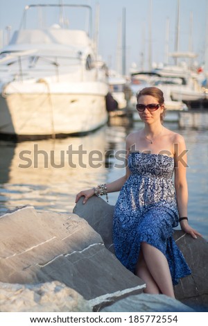 Beautiful russian girl with the boats at the rest of the day at the sunset