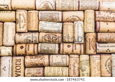Closeup pattern background of many different wine corks with dates and drops of wine