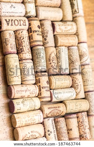 Closeup pattern background of many different wine corks with dates and drops of wine