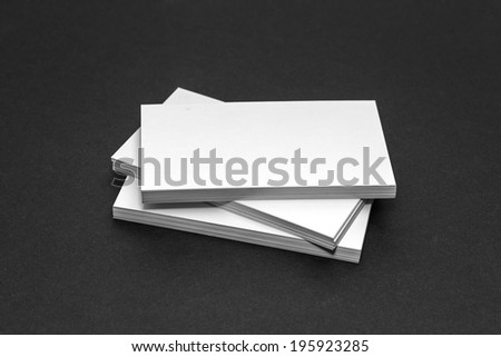 Business card template mockup for branding identity and logo prints with blank modern devices. Isolated on black paper background.