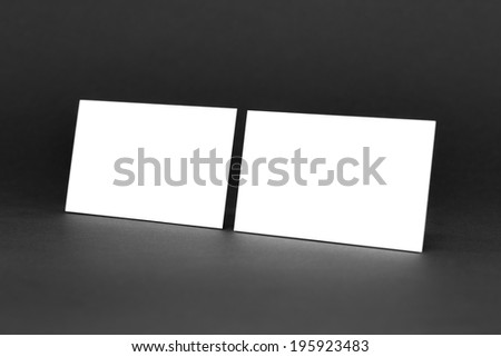 Business card template for branding identity with blank modern devices and modern abstract logo print. Isolated on gray paper background.