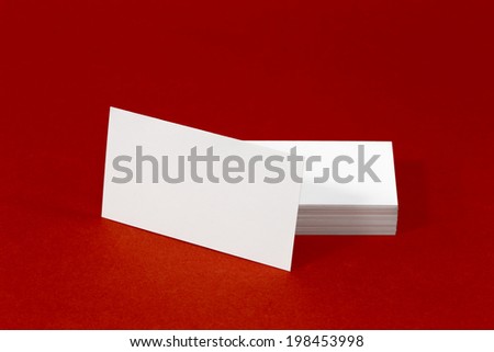Business card template mockup for branding identity with blank modern devices and modern abstract or hipster logo print. Isolated on red paper background.