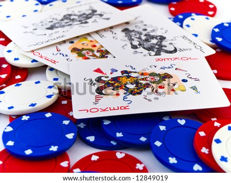 Red White and Blue Poker Chips and Jokers on White Background
