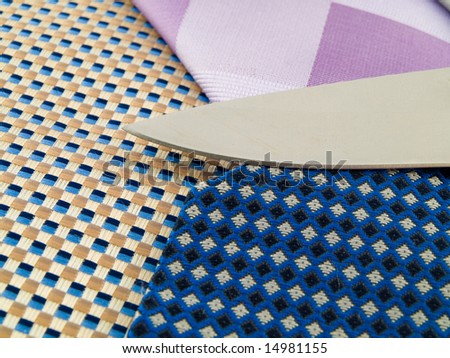 Close Up Neck Ties With Very Sharp Knife Metaphor For Cutting Edge