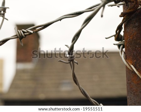 Barbed Wire Protecting House at Top of Wall