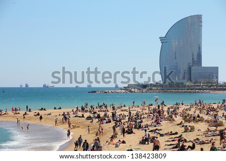 BARCELONA MAY 3 city beach 400 meters long it one of 10 best urban beaches of the world Tourists rest along Barceloneta beach May 03 2013 in Barcelona Spain BARCELONA MAY 3 city beach 400 meters long it one of 10 best urban beaches of the world Tourists rest along Barceloneta beach May 03 2013 in Barcelona Spain