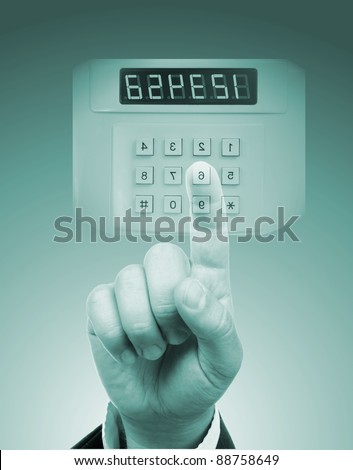 male hand entering safe or door code