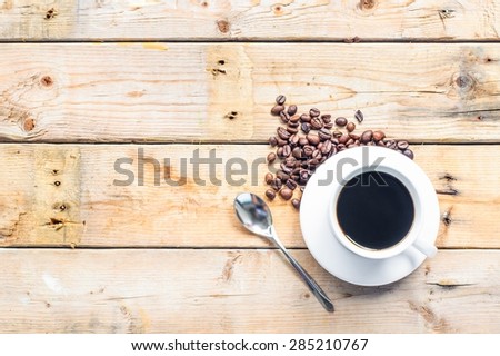 white coffee cup,coffee spoon and coffee  beans on wooden background