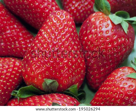 Ripe strawberry with leaves, texture, close-up