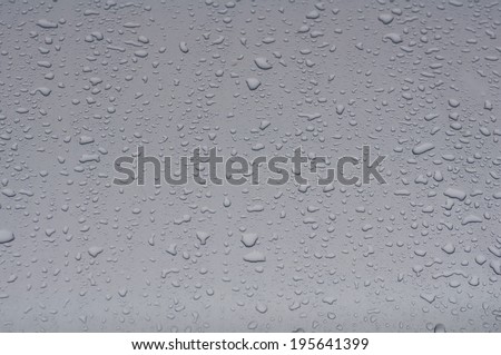 Texture silver hood of the car with raindrops