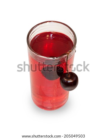 Glass of cherry juice with cherry hanging isolated on white background