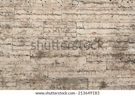 Texture of gray and yellow walls of porous stone