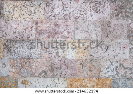 Texture of gray and yellow walls of porous stone