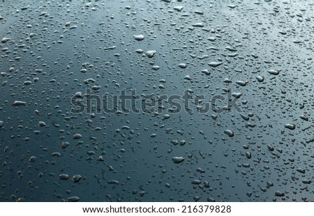 Texture black car hood with many rain drops