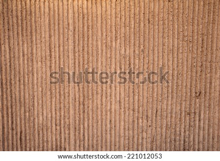Texture of wall covered with brown stucco with vertical relief