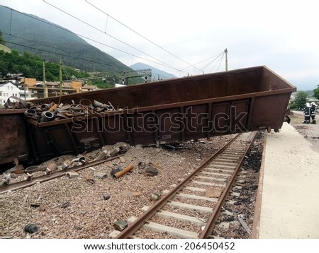 BRESSANONE, ITALY - JUNE 9, 2012: massive train crash derailment near the Bressanone station with paramedics and firefighters at work. Fireman at work near a wagon train derailed on June 9, 2012