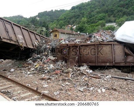 BRESSANONE, ITALY - JUNE 9, 2012: close up of massive train crash derailment near the Bressanone station. Wagon train derailed with industrial recycled metal pieces in Bressanone on June 9, 2012