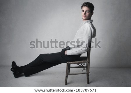 young handsome man relaxes sitting on a chair