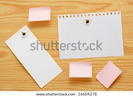 Paper for announcements of the different size on a background of wood.