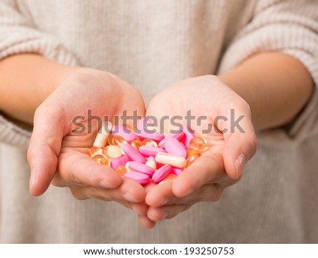 Close-up shot of a hand holding pills