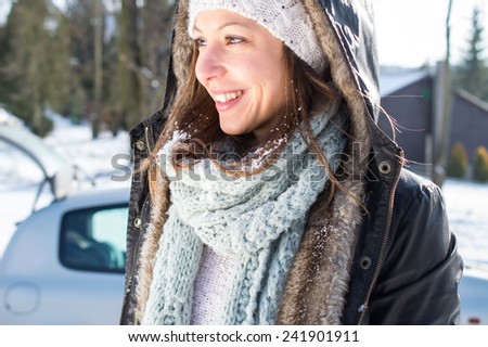 Girl enjoy snow and sunshine in winter by car
