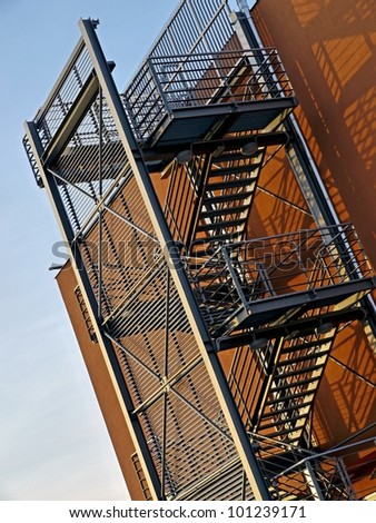 Steel emergency stairs on an orange commercial building