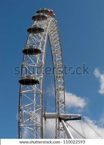 LONDON, UK - JULY 24:  Detail of one London Eye cabins with visitors against blue sky in one of the sunny days on July 24, 2011 in London, UK. It is the biggest, at 135 meters high, Ferris wheel.