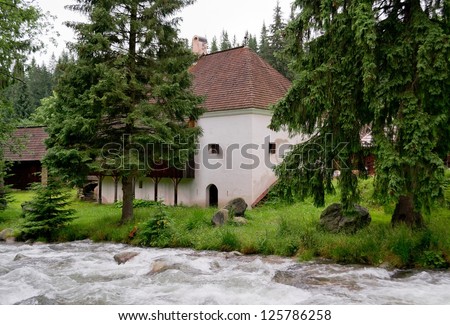 Historical house in nature with a forest and a river in Slovakia