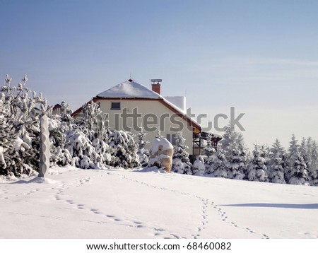 Family house in winter landscape with lot of snow