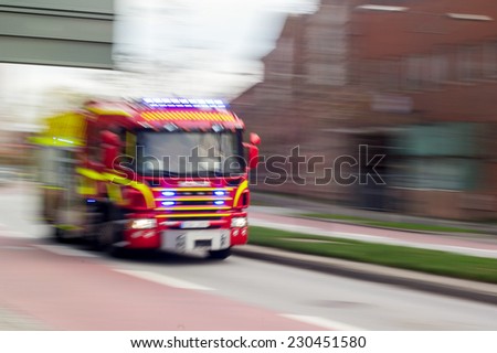 MALMO, SWEDEN - OCTOBER 26: Very fast driving red Scania fire truck in Malmo, Sweden on October 26, 2014.