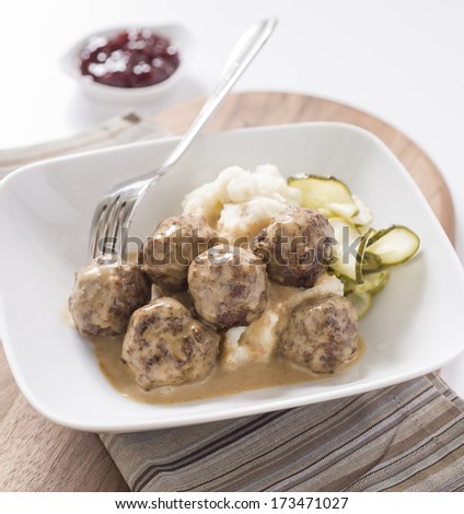 Swedish Meat balls in plate with mash potatoes and fork.