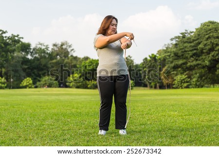 Obese woman is worrying about her overweight.