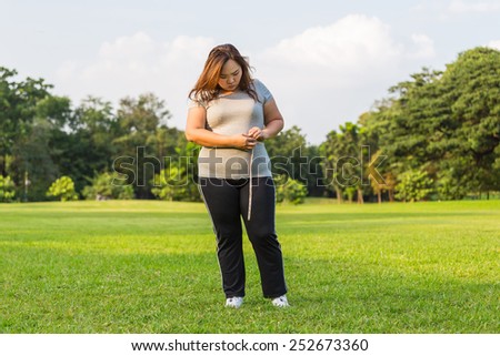 Obese woman is worrying about her overweight.