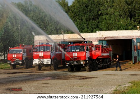 NIZHNY NOVGOROD. RUSSIA. JULY 31, 2014. STRIGINO AIRPORT. The fire truck with working fire engines gives two powerful streams of water.