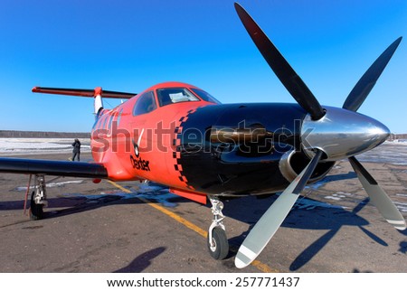 NIZHNY NOVGOROD. RUSSIA. FEBRUARY 17, 2015. The Pilatus light airplane of the Dexter company on the airport platform. A look along the right board.