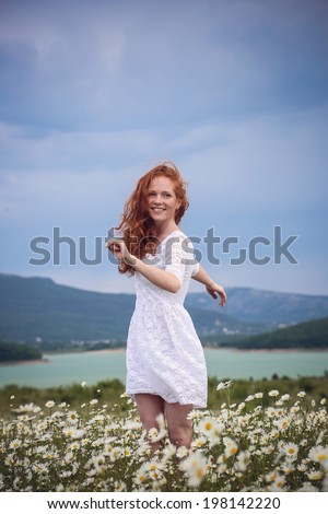 Beautiful woman enjoying field, pretty girl relaxing outdoor, having fun, holding plant, happy young lady and spring green nature, harmony concept