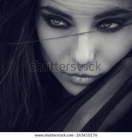Closeup Portrait of beautiful young woman. Black and white Young active people. Outdoors.  Smoky eyes. Fashion colors. Cold sea