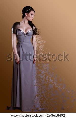 Warrior woman. Fantasy fashion idea. beautiful girl in armor     Portrait of a beautiful lady warrior, dark-haired girl in a gray melting dress. bright makeup, hairstyle, spikes.