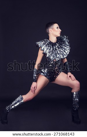 sexy disco party woman dressed in a unique silver costume with metal collar. Perfect for stylish club, disco and fashion events