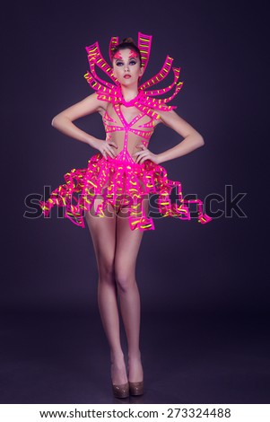 sexy female disco dancer poses in UV costume