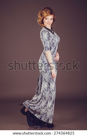 Studio photo of a young woman in retro style, evening dress and jewelry,