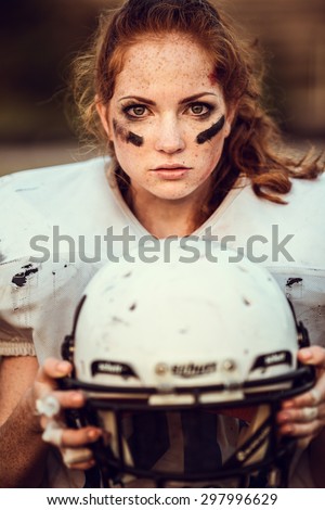 American football woman player in action on the stadium .