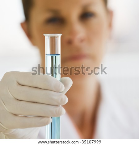 Female Scientist holding up Test Tube