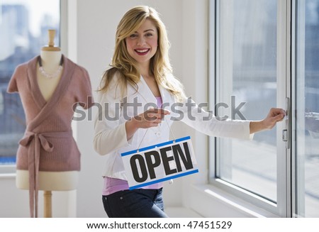 female clothing store worker opening up shop